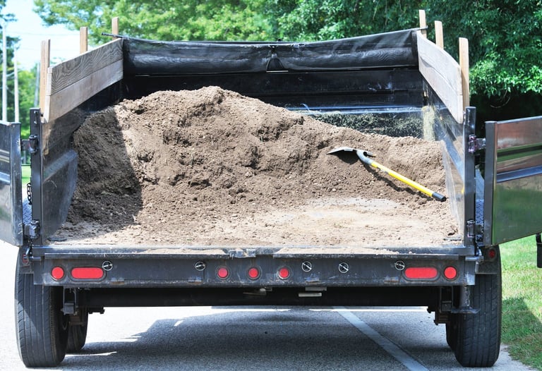 Load of dirt with shovel in wagon or truck
