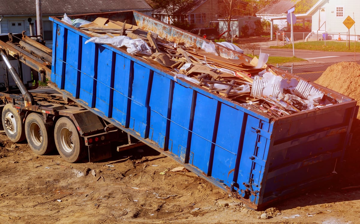 Construction debris container with rock and concrete rubble