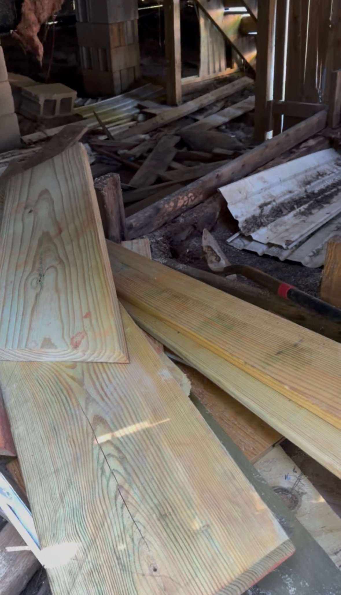 Assorted lumber and wood planks stacked in a workshop or storage area